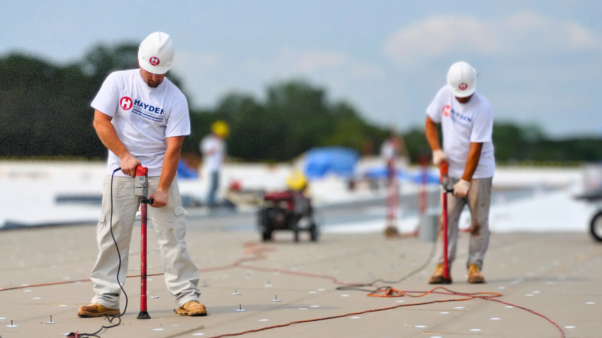HBMC team performing rooftop inspection and consulting for a commercial property
