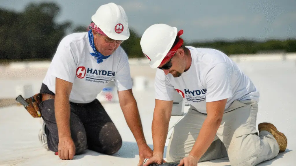 HBMC technicians performing preventative maintenance on a commercial flat roof