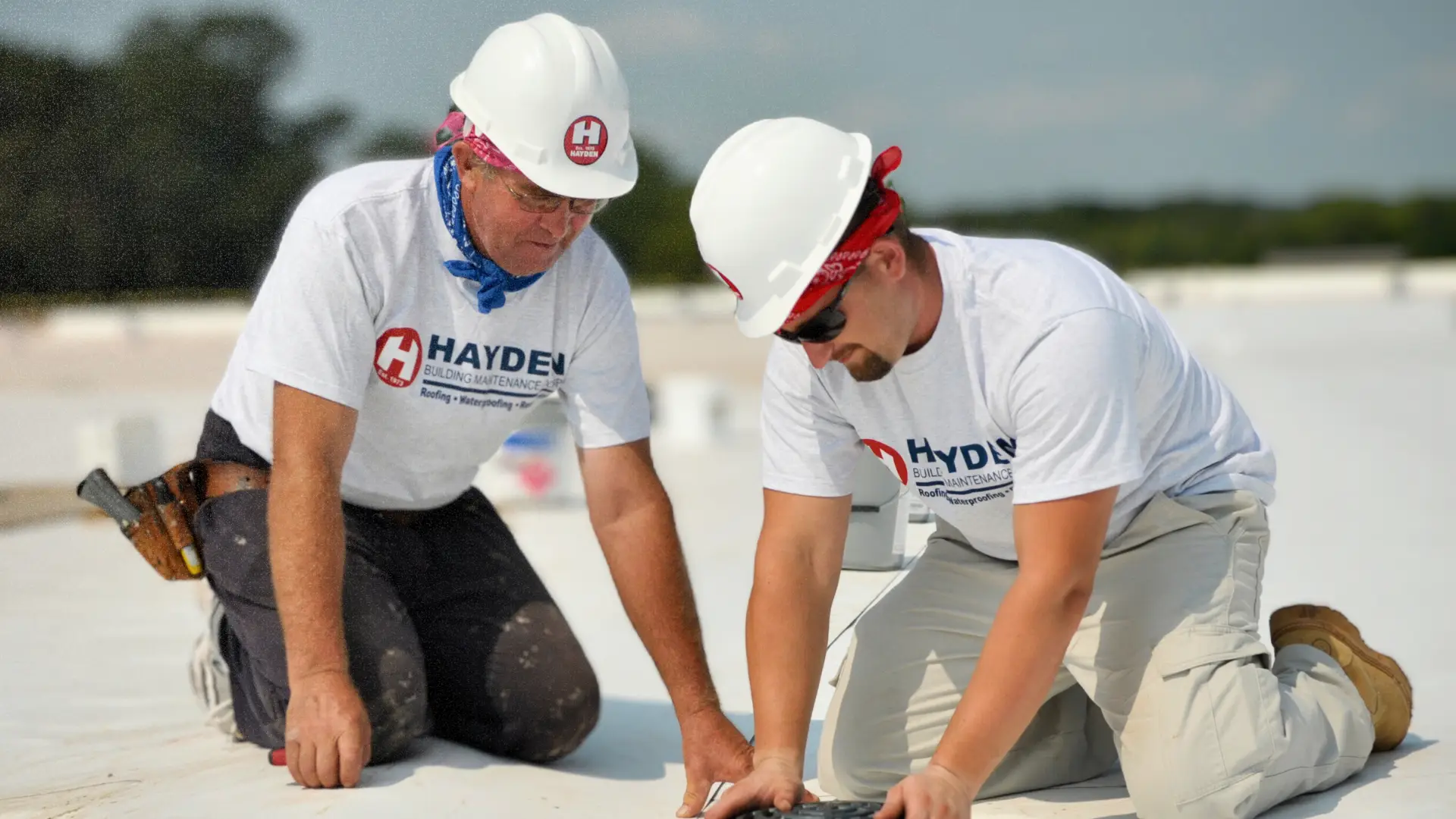 HBMC technicians performing preventative maintenance on a commercial flat roof
